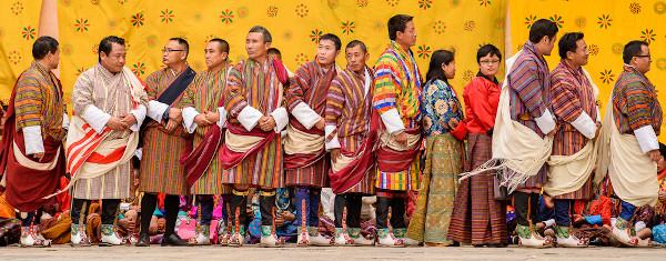 Homens e mulheres com suas roupas tradicionais durante cerimônia religiosa em Thimphu.[1]