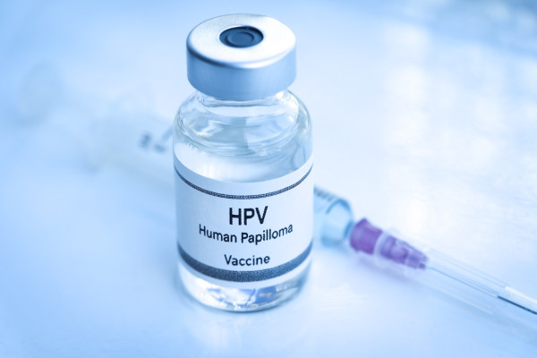 Seringa ao lado de um frasco com a vacina contra o HPV.