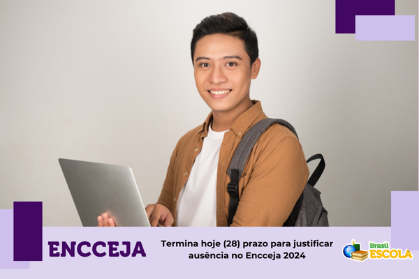 Justificativa de ausência do Enem 2024 Estudante de origem oriental segurando notebook
