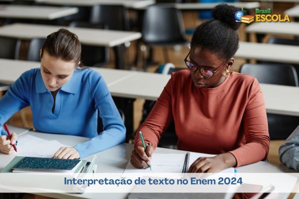 Estudantes em mesa escolar fazendo prova, uma negra e uma branca. Texto Interpretação de texto no Enem 2024